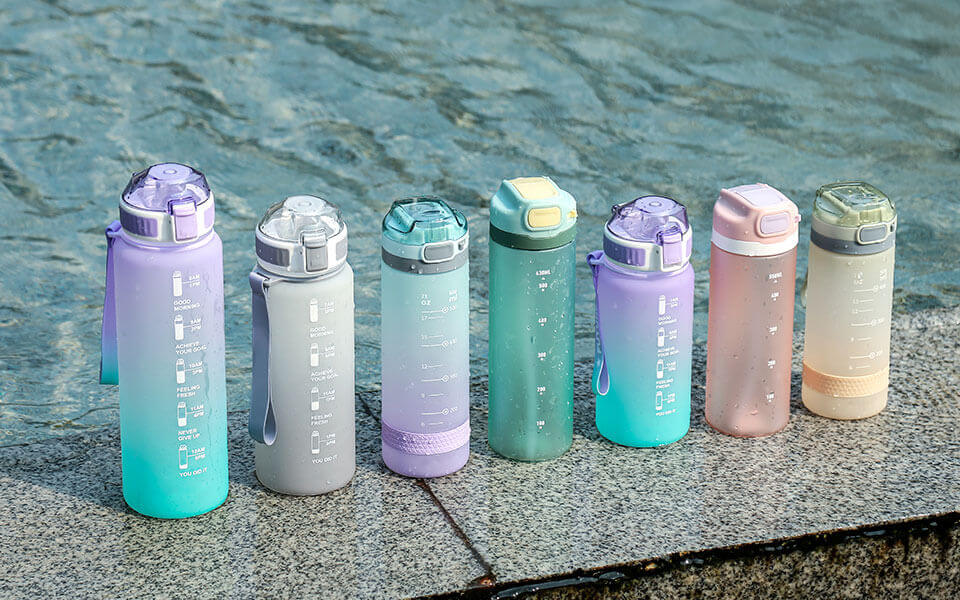 Colorful BPA-free water bottles displayed beside a swimming pool to promote healthy hydration and eco-friendly reusable drinkware.